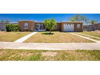 Charming single-story home featuring a well-maintained front yard and an attached single-car garage at 159 Godfrey Ne Ave, Port Charlotte, FL 33952