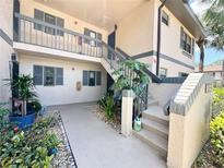 Inviting exterior of condo with well-maintained landscaping and a stairway to the second level at 19505 Quesada Ave # Ii201, Port Charlotte, FL 33948
