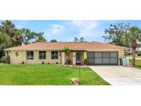 Charming single-story home featuring a well-manicured lawn and a welcoming front entrance, blending comfort and curb appeal at 20355 Mount Prospect Ave, Port Charlotte, FL 33952