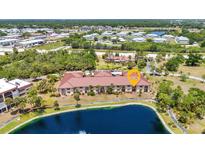 Beautiful aerial view of the condo complex, showcasing the landscaping, nearby pond, and well-maintained grounds at 23465 Harborview Rd # 1002, Punta Gorda, FL 33980