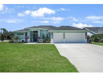 Charming single-story home with a well-manicured lawn and a two-car garage at 25273 Paraguay St, Punta Gorda, FL 33983