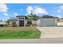 Charming home features a spacious two-car garage and a well-manicured lawn at 3544 Monfero Ave, North Port, FL 34286