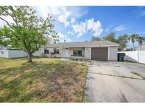 Charming single-story home with a well-maintained lawn and an attached one car garage at 4243 Hokan Ave, North Port, FL 34287