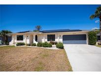 Charming single-story home with well-maintained landscaping and a two-car garage at 4339 Boggs St, Port Charlotte, FL 33948