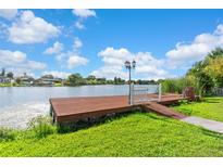 Waterfront property with personal dock and walkway on a sunny day at 6604 Ranger Dr, Tampa, FL 33615