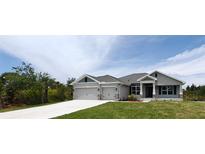 Charming single-story home with a three car garage and well-manicured lawn at 13236 Pace Cir, Port Charlotte, FL 33981