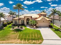 Stunning single Gathering home with a beautiful, well maintained lawn, mature palm trees, and a metal roof at 1367 Grebe Dr, Punta Gorda, FL 33950