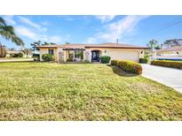 Single-story home featuring a well-manicured lawn and landscaping at 3663 Sterling Rd, Venice, FL 34293