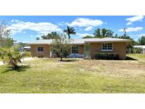 Charming single-story home with well-maintained lawn and mature landscaping at 700 Dolphin Pkwy, Punta Gorda, FL 33950