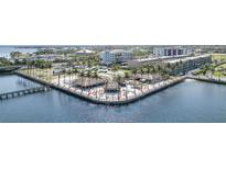 Aerial view of waterfront entertainment venue with tiki huts and colorful seating near hotels and the harbor at 150 Harborside Ave # 306, Punta Gorda, FL 33950