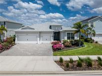 Charming one-story home featuring a two-car garage, lovely landscaping, and a brick paved driveway at 17924 Corkwood Bend Trl, Punta Gorda, FL 33982
