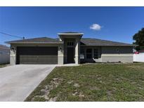 Inviting single-story home with a well-manicured lawn and neutral exterior paint at 2250 Homestead Cir, North Port, FL 34286