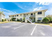 Inviting two-story condo featuring stairways leading to upper-level units and well-manicured landscaping at 25225 Rampart Blvd # 1603, Punta Gorda, FL 33983