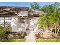 Charming single story home with a well manicured lawn, stone accents, and lovely palm trees at 5301 Linksman Pl, North Port, FL 34287