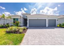 Beautiful single-story home with a three-car garage and well-maintained landscaping at 8488 Saint Kitts Cir, Englewood, FL 34224