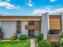 Inviting condo exterior with well-maintained landscaping and a walkway leading to the entrance at 1080 Bal Harbor Blvd # 11C, Punta Gorda, FL 33950