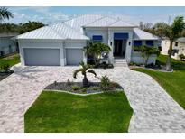 Stunning aerial view of the single-story home, landscaped yard, and circular driveway at 1306 Osprey Dr, Punta Gorda, FL 33950