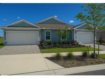 Charming single-story home with a two-car garage and well-maintained landscaping at 16909 Caracara Pl, Punta Gorda, FL 33982