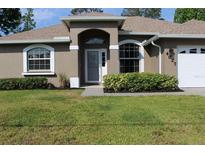 Well maintained single story home with lush landscaping and beautiful lawn at 4027 Quaker Ln, North Port, FL 34288