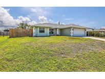 Charming single-story home with lush lawn, white trim, complemented by a well-maintained, two-car garage at 5331 Citadel Rd, Venice, FL 34293