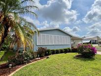 Charming home featuring manicured landscaping with lush greenery and colorful flowers, offering curb appeal at 857 Seabrooke Dr, Englewood, FL 34223