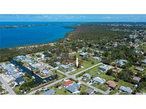 Wide aerial view of a neighborhood showcasing a waterfront community with lush surroundings and nearby ocean access at 900 Stewart St, Englewood, FL 34223