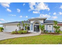 Charming single Gathering home featuring a two-car garage and a well-manicured lawn at 1 Sportsman Way, Rotonda West, FL 33947