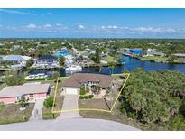 Beautiful waterfront home with lush landscaping and a private dock with ocean access in a desirable neighborhood at 18602 Ashcroft Cir, Port Charlotte, FL 33948