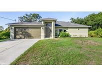 Charming single-story home with a well-maintained lawn and two-car garage in a lovely neighborhood at 2381 Sheila Ln, North Port, FL 34286