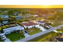 Beautiful aerial view of waterfront homes with well-maintained lawns and canal access at sunset at 3301 Santa Barbara Dr, Punta Gorda, FL 33983