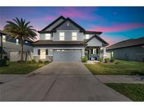 Charming two-story home features a well-manicured lawn, inviting front porch and attached two-car garage at 8277 Abby Brooks Cir, Wesley Chapel, FL 33545