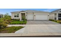 Charming single-story home with a well-maintained lawn and a two-car garage, offering curb appeal and convenience at 16440 Marsh Ln, Punta Gorda, FL 33982