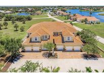 Attractive townhome with red tile roof and multiple car garages and brick paved driveway at 16572 San Edmundo Rd # 111, Punta Gorda, FL 33955