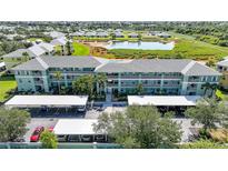 Well-maintained condo building with lush landscaping, covered parking, and a serene lake view in a desirable community at 2160 Heron Lake Dr # 201, Punta Gorda, FL 33983