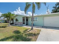 Charming single-story home with a well-maintained lawn and mature palm trees at 281 Seminole Nw Blvd, Port Charlotte, FL 33952