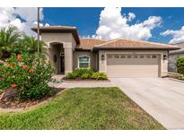 Charming single-story home featuring a tile roof, two-car garage and well-maintained landscaping at 2913 Royal Palm Dr, North Port, FL 34288