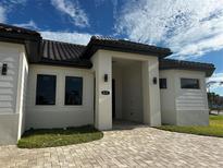 Beautiful front entrance to this property featuring custom brickwork and a modern, covered entryway at 432 Gun Cay Ln, Punta Gorda, FL 33950