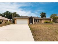 Charming single-story home featuring a two-car garage, screened entry and well-maintained landscaping at 4788 Abadan St, North Port, FL 34287
