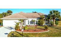 Attractive single-story home with well-manicured landscaping and a charming front yard at 279 Mariner Ln, Rotonda West, FL 33947