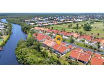 Beautiful aerial view of the community with a river and golf course nearby at 5046 San Rocco Ct, Punta Gorda, FL 33950