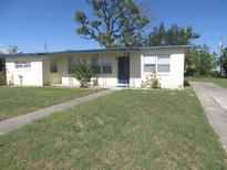 Charming single-story home with a well-maintained lawn, sidewalk, and a welcoming blue front door at 139 Dow Rd, Port Charlotte, FL 33952