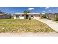 Charming single-story home featuring a light-colored exterior and a well-maintained front yard at 4035 Mcintire St, Port Charlotte, FL 33948