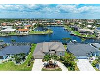Beautiful waterfront home with lush landscaping and a circular driveway in a desirable neighborhood at 414 Caicos Dr, Punta Gorda, FL 33950