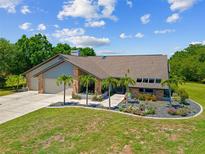 Beautiful single-story home with a well-manicured lawn, elegant landscaping, and a two-car garage at 501 Fairmont Ter, Port Charlotte, FL 33954