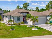 Charming single-story home with well-maintained landscaping, paver driveway, and welcoming curb appeal at 111 Britt Rd, Rotonda West, FL 33947