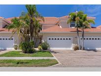 Charming townhome with paver driveway, two-car garage and well-manicured landscaping, creating a welcoming curb appeal at 143 Tropicana Dr # 1012, Punta Gorda, FL 33950