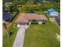 Well-maintained home featuring a long driveway and large grassy front yard at 2119 Pellam Blvd, Port Charlotte, FL 33948