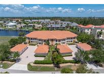 Gorgeous condo building with beautiful tile roof, well maintained landscaping and individual garages at 3314 Wood Thrush Dr # 124, Punta Gorda, FL 33950