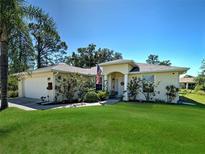 Charming single-story home with a well-manicured lawn and an inviting front entrance at 4092 Troost St, North Port, FL 34288