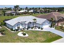 Beautiful single-Gathering home featuring a well-maintained lawn, manicured landscaping and a long driveway at 7148 N Blue Sage, Punta Gorda, FL 33955